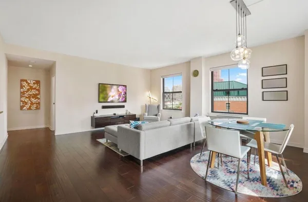 a living room with fireplace furniture and a table