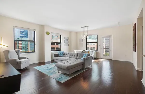 a living room with furniture window and wooden floor