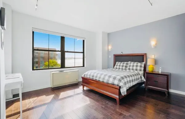 a bedroom with a bed and window