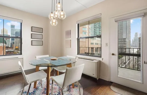 a dining room with furniture a chandelier and wooden floor