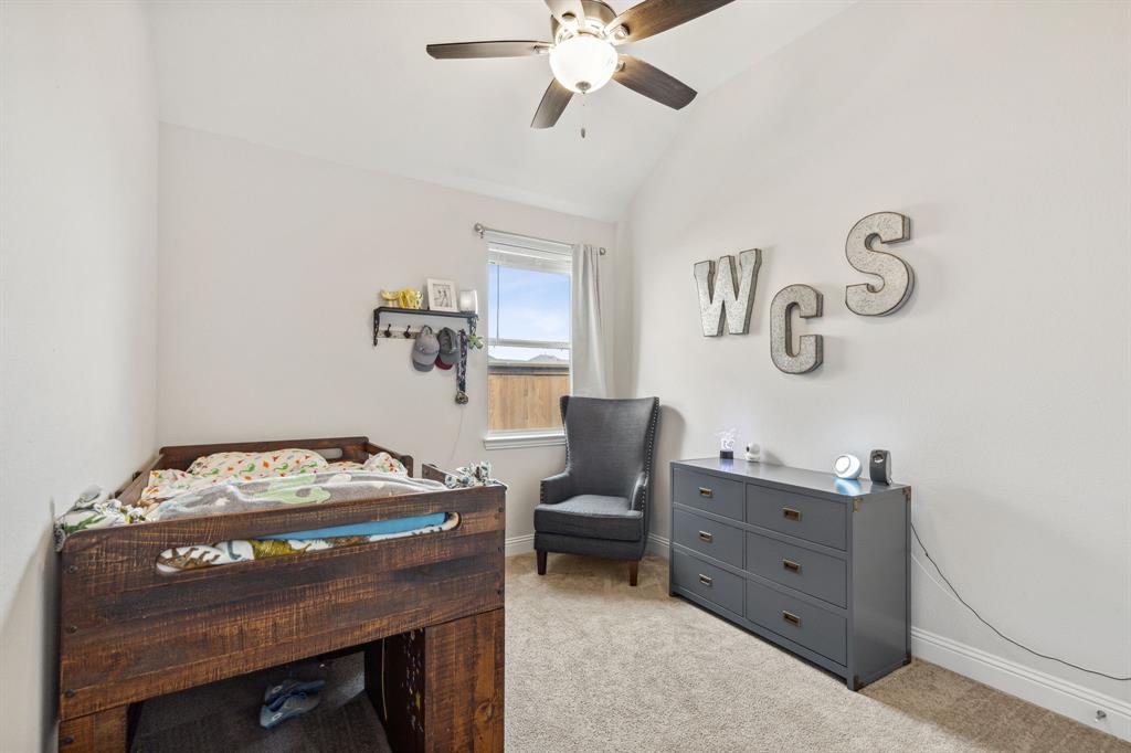 482 Prairie View Drive Haslet, TX 76052 - Photo 16 of 33 a bedroom with a bed and a table in it