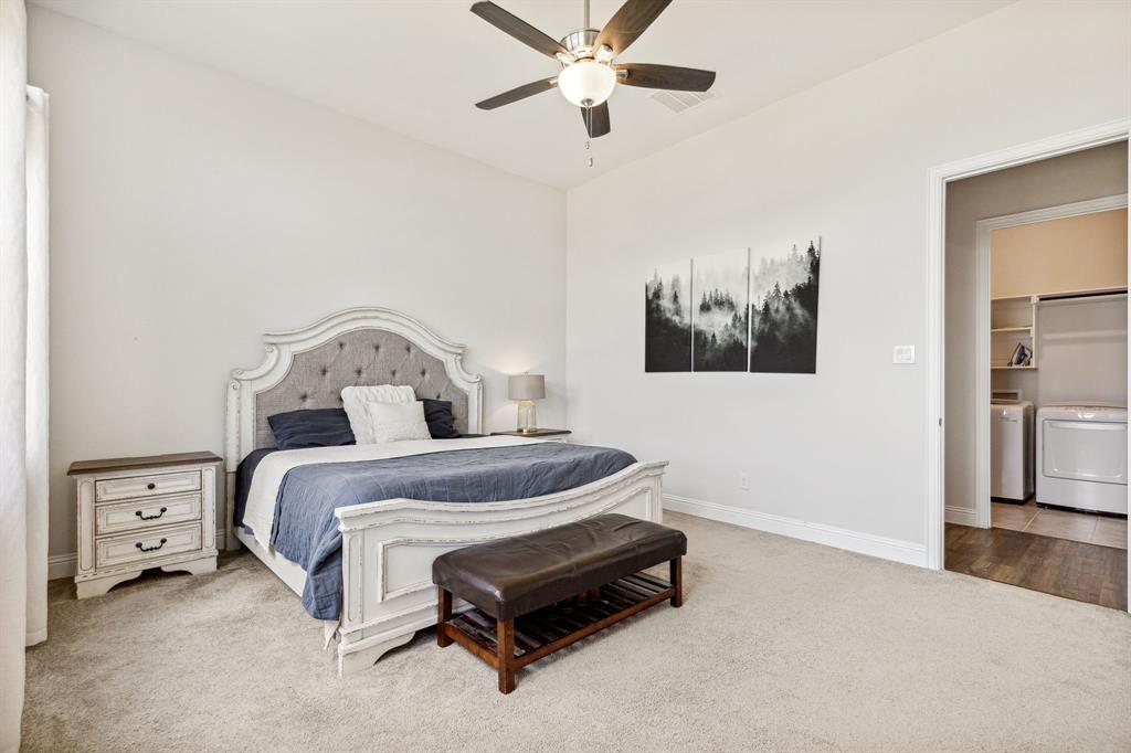 482 Prairie View Drive Haslet, TX 76052 - Photo 19 of 33 a bedroom with a bed and a chandelier