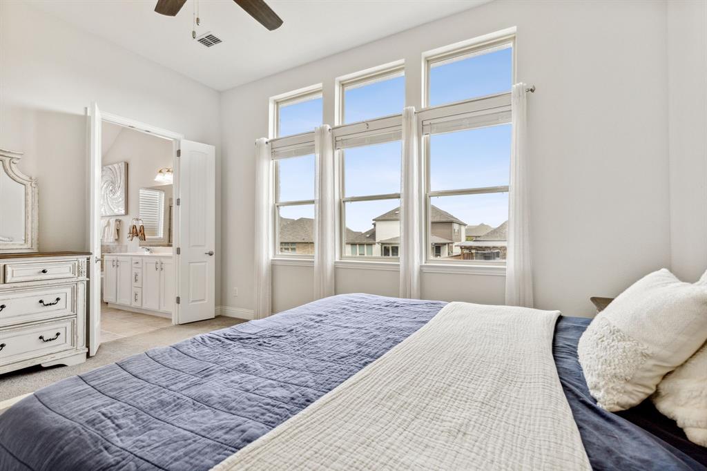 482 Prairie View Drive Haslet, TX 76052 - Photo 20 of 33 a bedroom with a large bed and a dresser