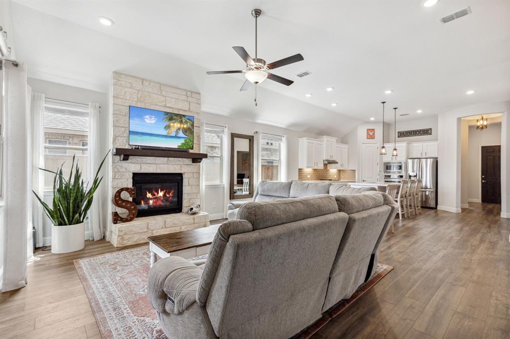 482 Prairie View Drive Haslet, TX 76052 - Photo 3 of 33 a living room with furniture and a fireplace with wooden floor