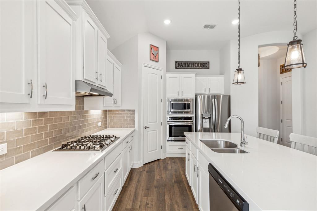 482 Prairie View Drive Haslet, TX 76052 - Photo 9 of 33 a kitchen with stainless steel appliances kitchen island a sink stove and refrigerator