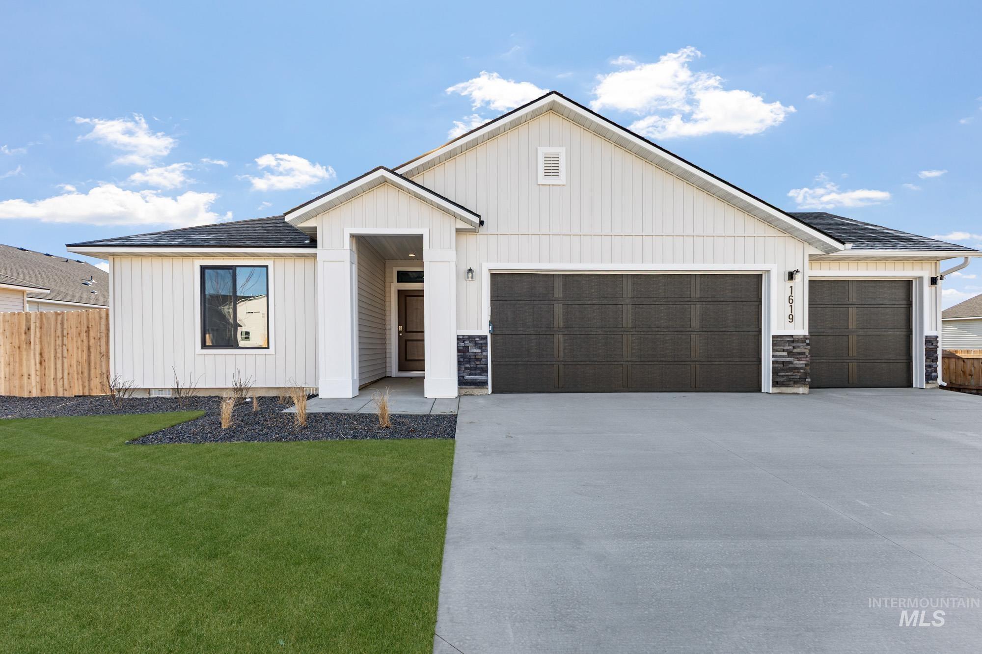 1619 Long Pond Street Middleton, ID 83644 - Photo 1 of 1 Modern inspired farmhouse featuring concrete driveway, a garage, board and batten siding, and a shingled roof
