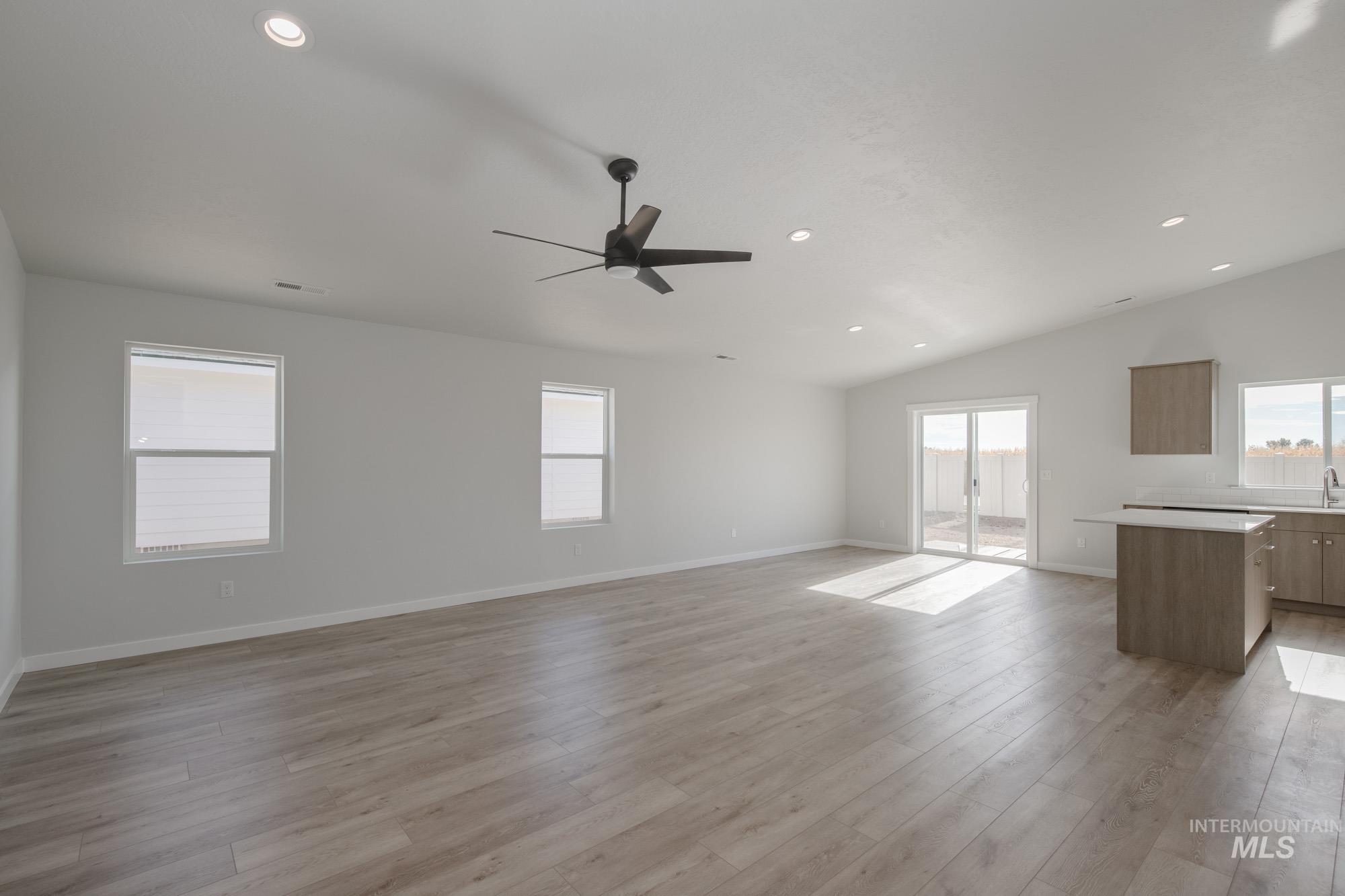 1619 Long Pond Street Middleton, ID 83644 - Photo 11 of 21 Unfurnished living room with recessed lighting, ceiling fan, light wood-style flooring, and lofted ceiling