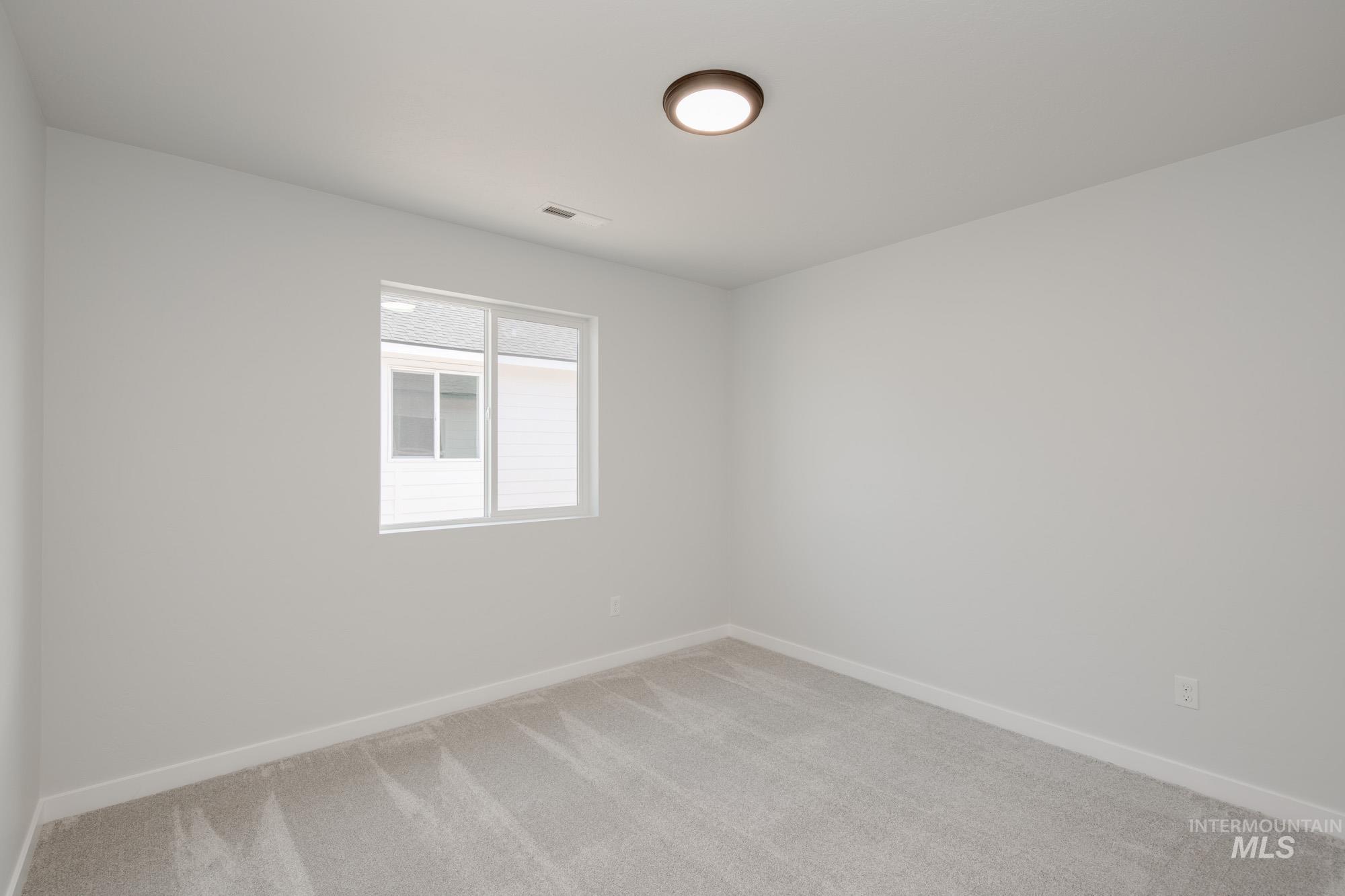 1619 Long Pond Street Middleton, ID 83644 - Photo 15 of 21 Spare room featuring light carpet and baseboards