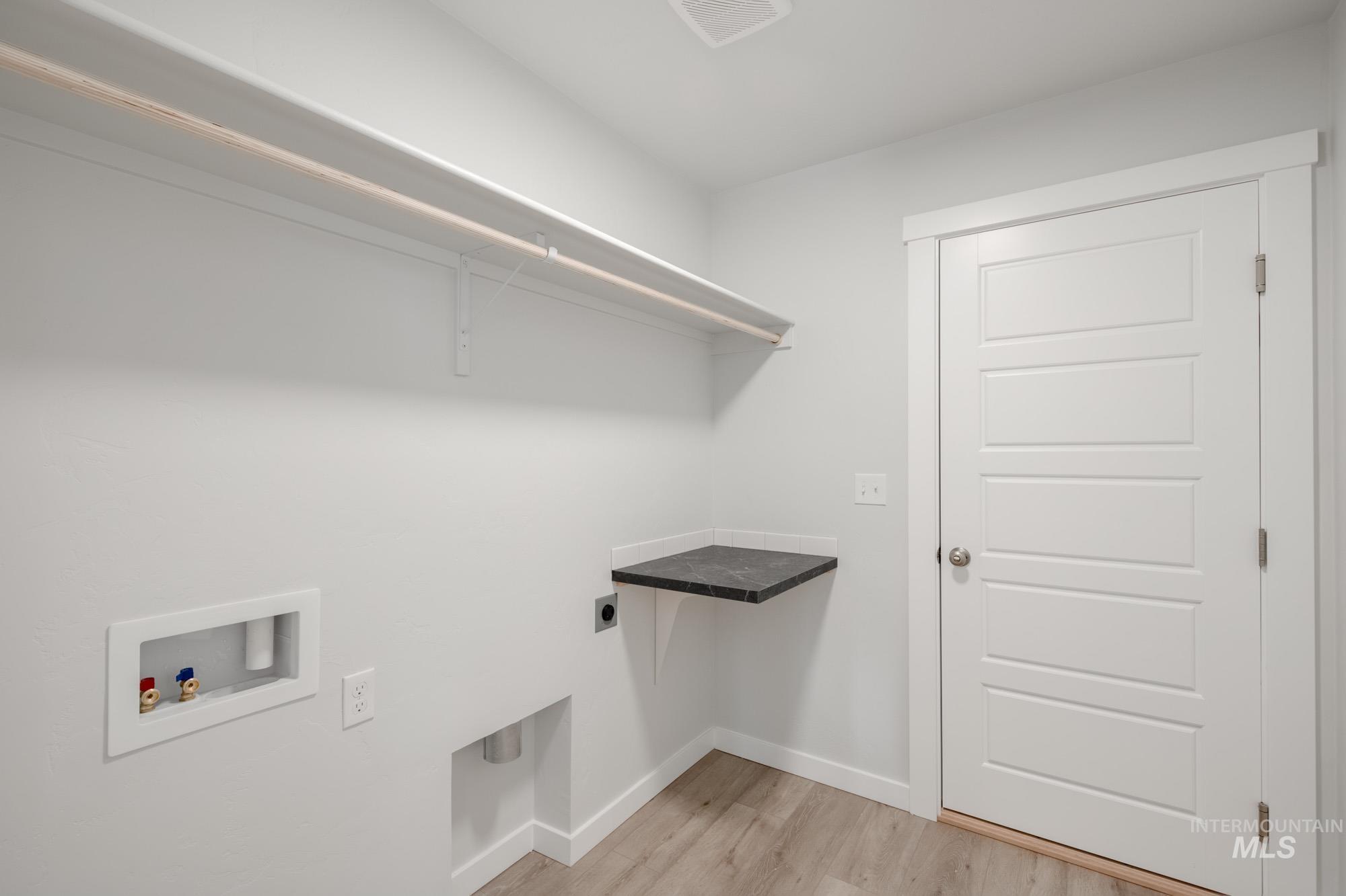1619 Long Pond Street Middleton, ID 83644 - Photo 17 of 21 Laundry area featuring light wood finished floors, washer hookup, and hookup for an electric dryer