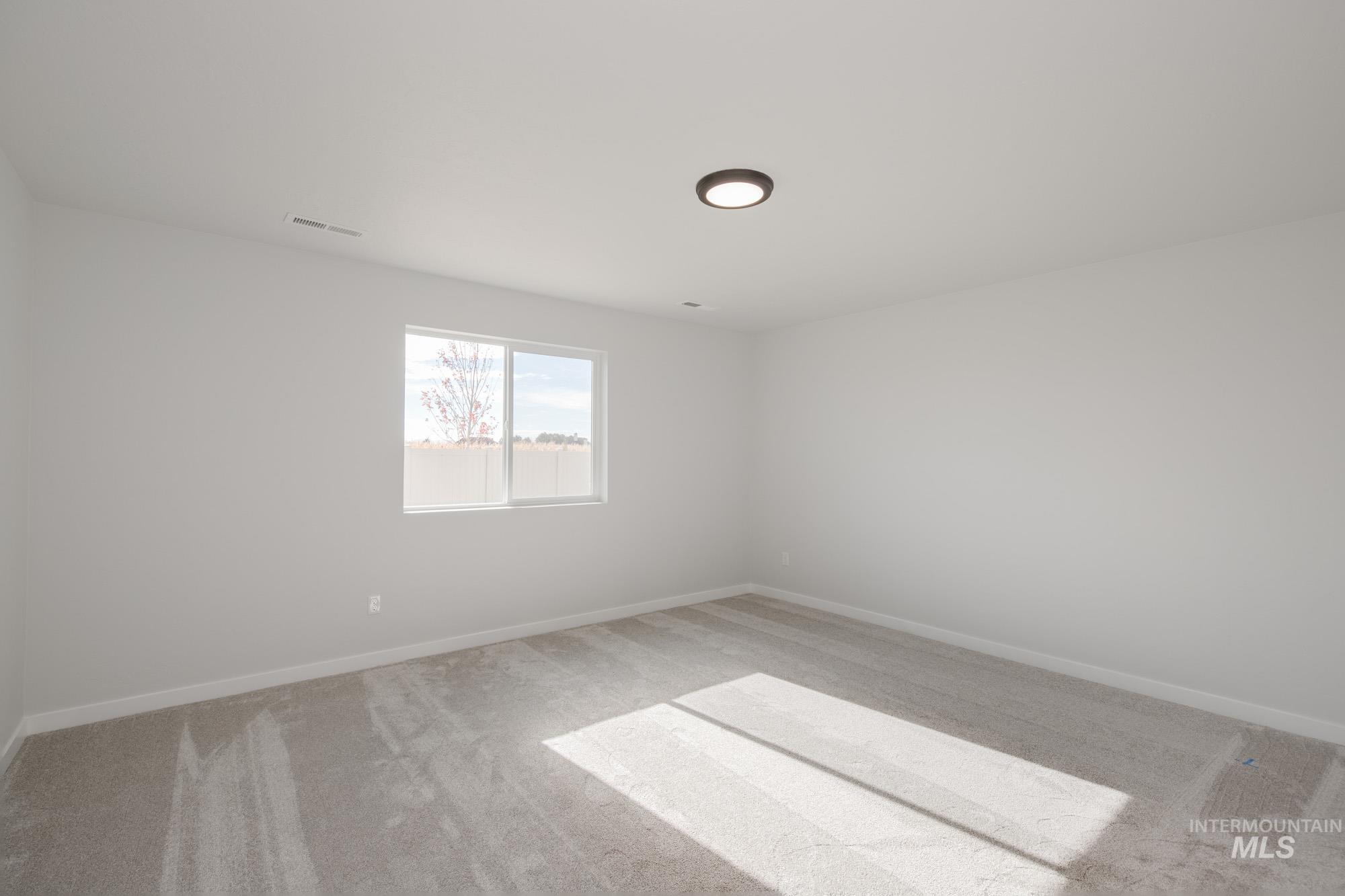 1619 Long Pond Street Middleton, ID 83644 - Photo 19 of 21 Unfurnished room with light carpet and baseboards