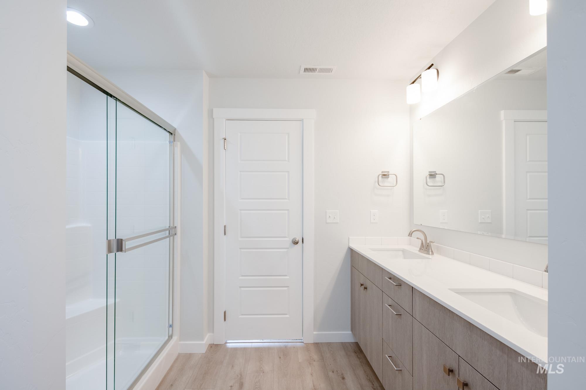 1619 Long Pond Street Middleton, ID 83644 - Photo 21 of 21 Bathroom featuring light wood-style floors, double vanity, a shower stall, and recessed lighting