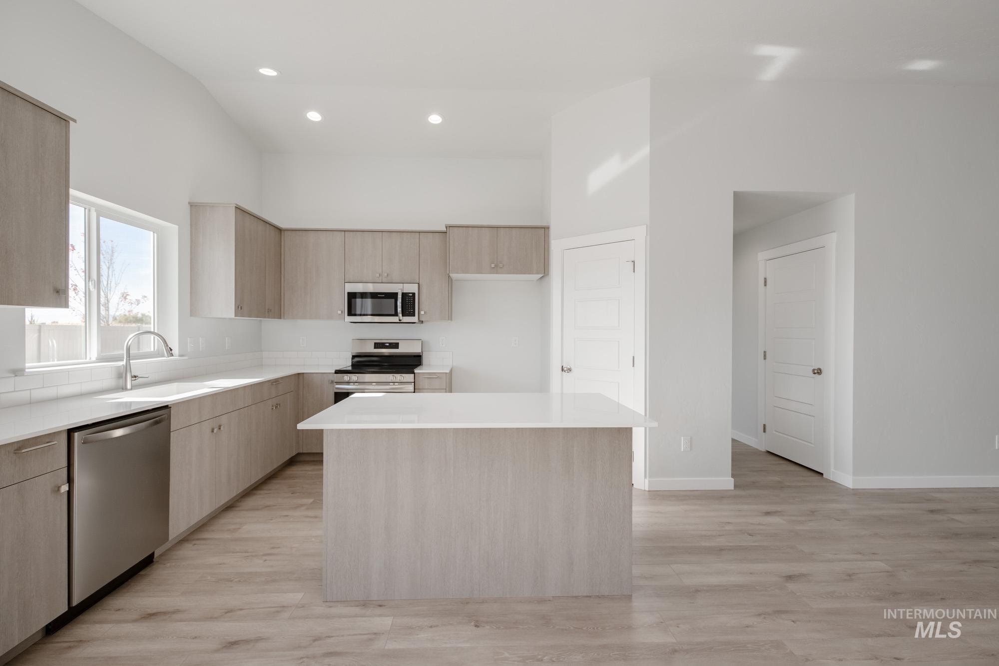 1619 Long Pond Street Middleton, ID 83644 - Photo 3 of 21 Kitchen with light brown cabinets, modern cabinets, stainless steel appliances, recessed lighting, and light stone counters