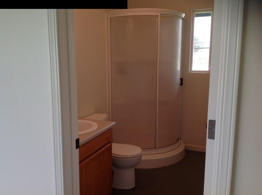 2750 Kokomo Road Haiku, HI 96708 - Photo 20 of 30 a bathroom with a granite countertop toilet a sink and a mirror