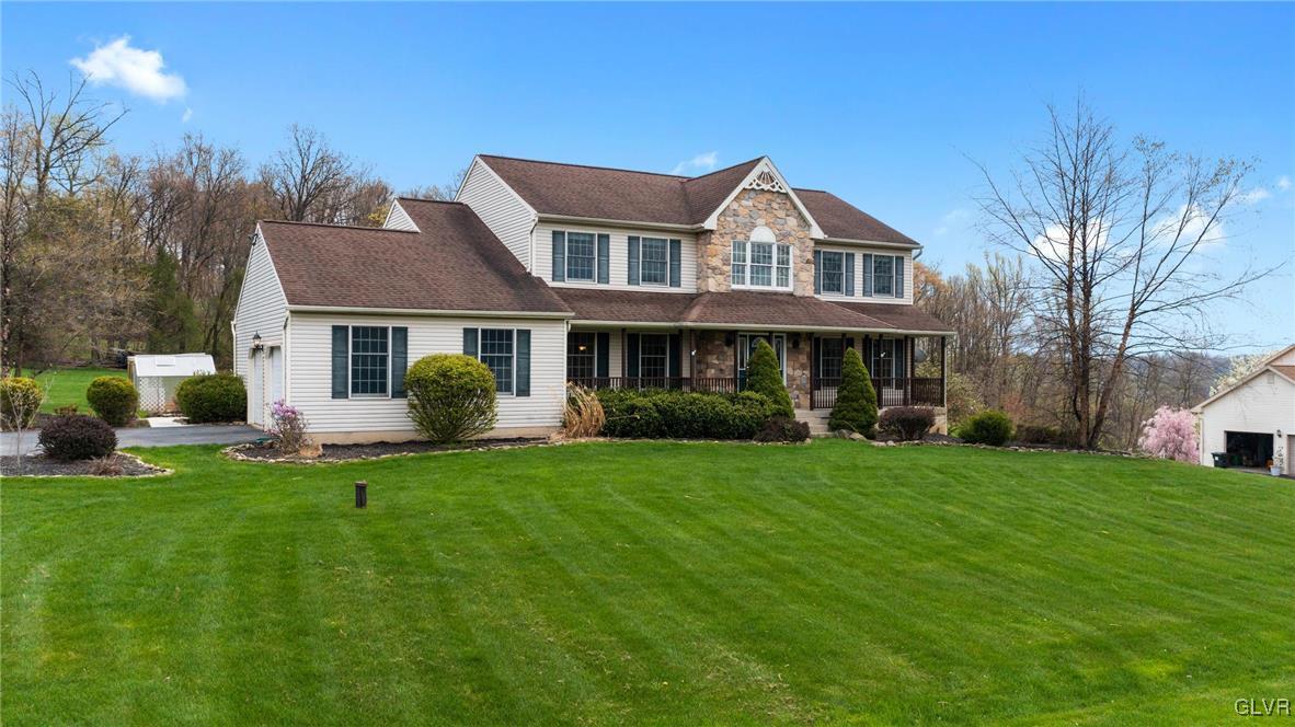 180 West Butternut Road Hellertown, PA 18055 - Photo 1 of 50 a front view of a house with a garden