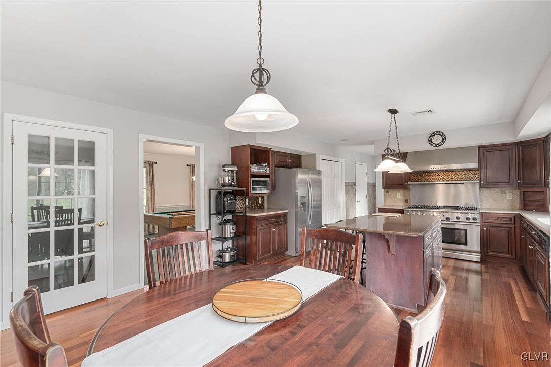 180 West Butternut Road Hellertown, PA 18055 - Photo 20 of 50 a kitchen with stainless steel appliances a dining table chairs and wooden floor