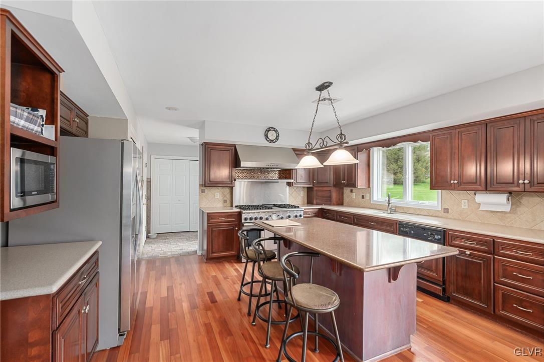 180 West Butternut Road Hellertown, PA 18055 - Photo 22 of 50 a kitchen with stainless steel appliances granite countertop a sink a stove and a wooden floors