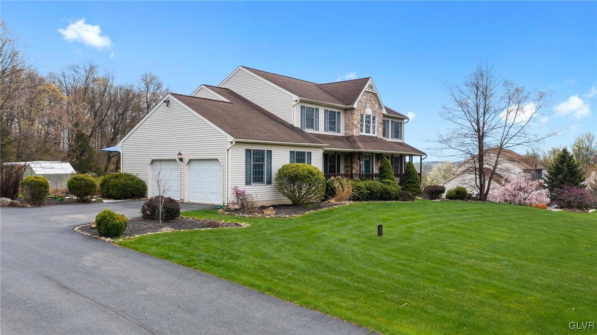 180 West Butternut Road Hellertown, PA 18055 - Photo 3 of 50 a front view of a house with garden and porch