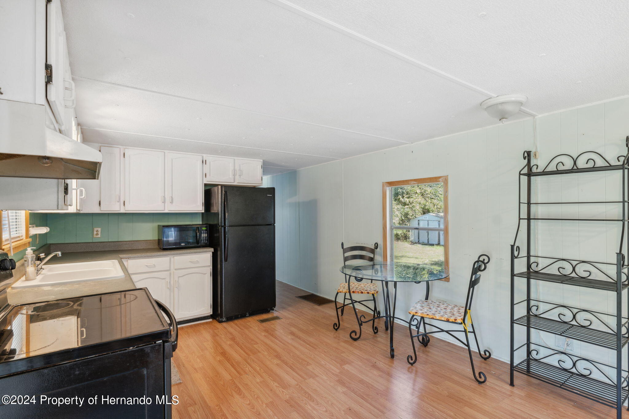 10327 East Victory Lane Inverness, FL 34450 - Photo 13 of 35 a kitchen with stainless steel appliances granite countertop a refrigerator and a stove top oven