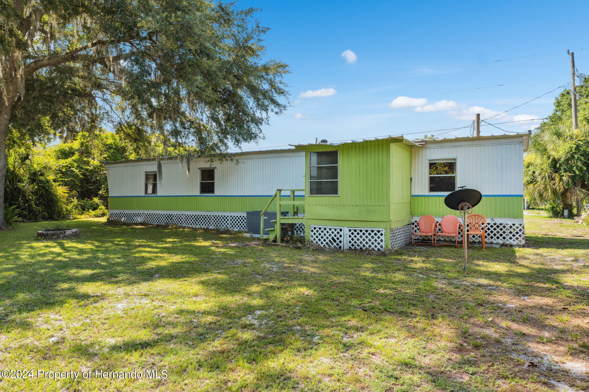 10327 East Victory Lane Inverness, FL 34450 - Photo 22 of 35 a view of a house with a yard and sitting area