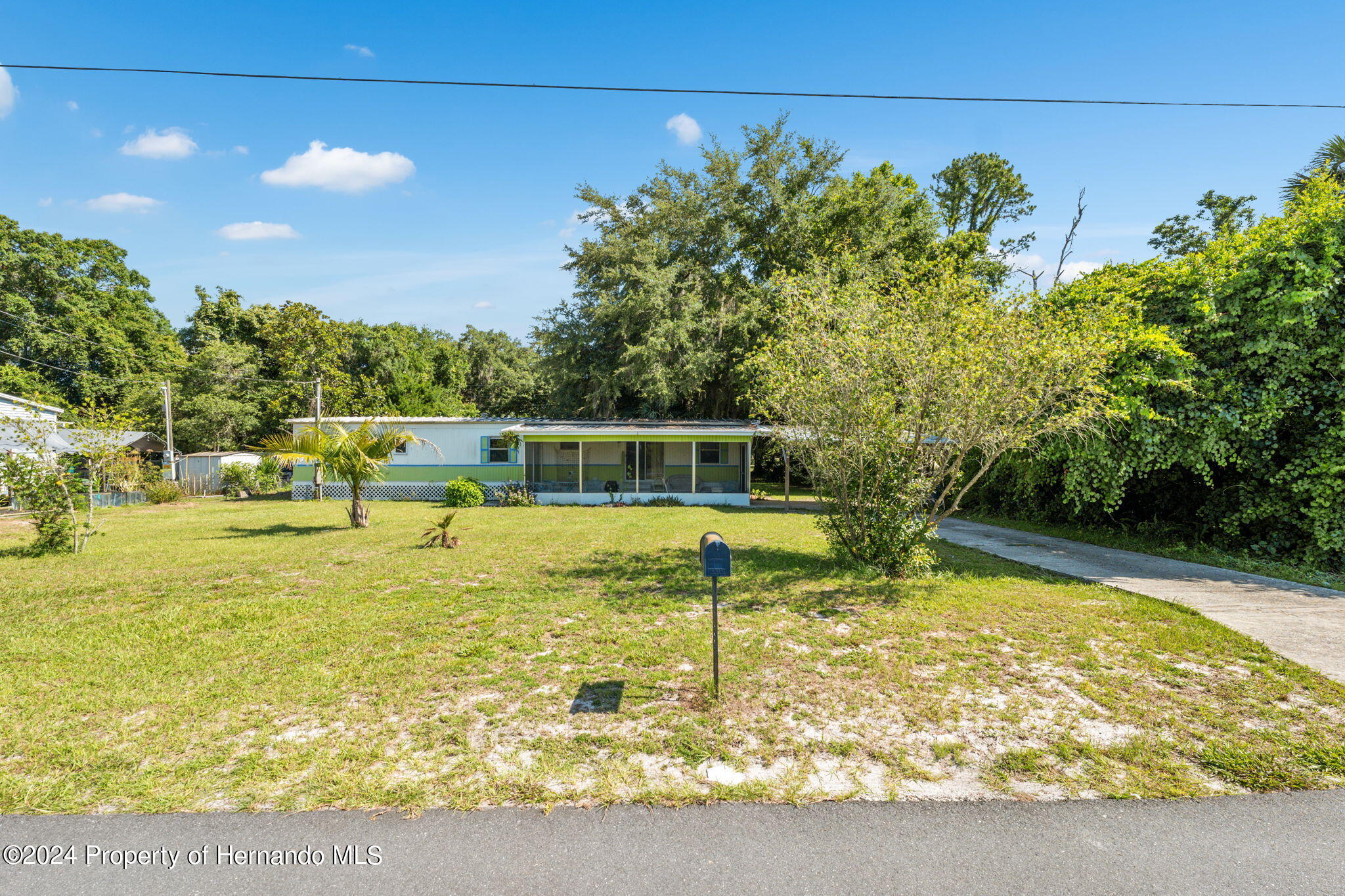10327 East Victory Lane Inverness, FL 34450 - Photo 26 of 35 a view of a swimming pool with an outdoor seating area