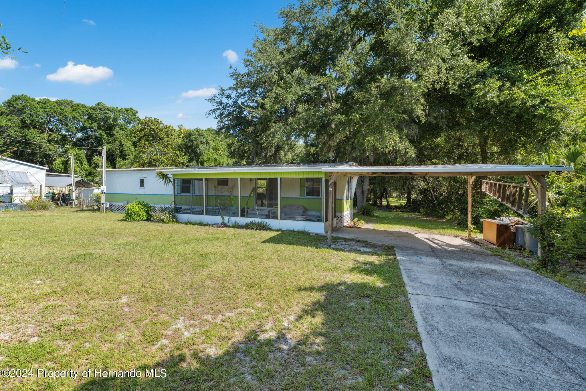10327 East Victory Lane Inverness, FL 34450 - Photo 3 of 35 a view of backyard with swimming pool and seating space