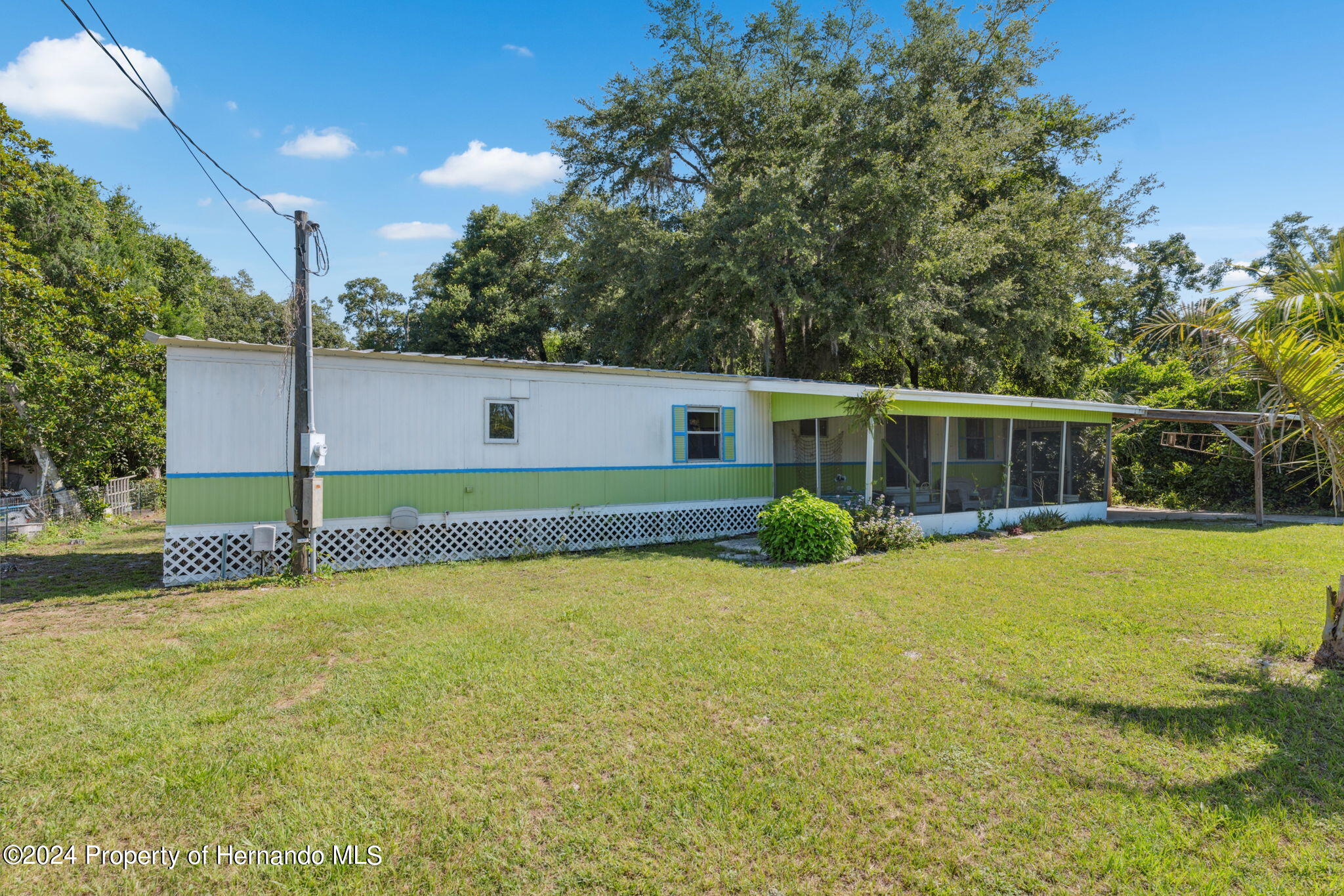 10327 East Victory Lane Inverness, FL 34450 - Photo 4 of 35 a view of a house with a yard and a garden