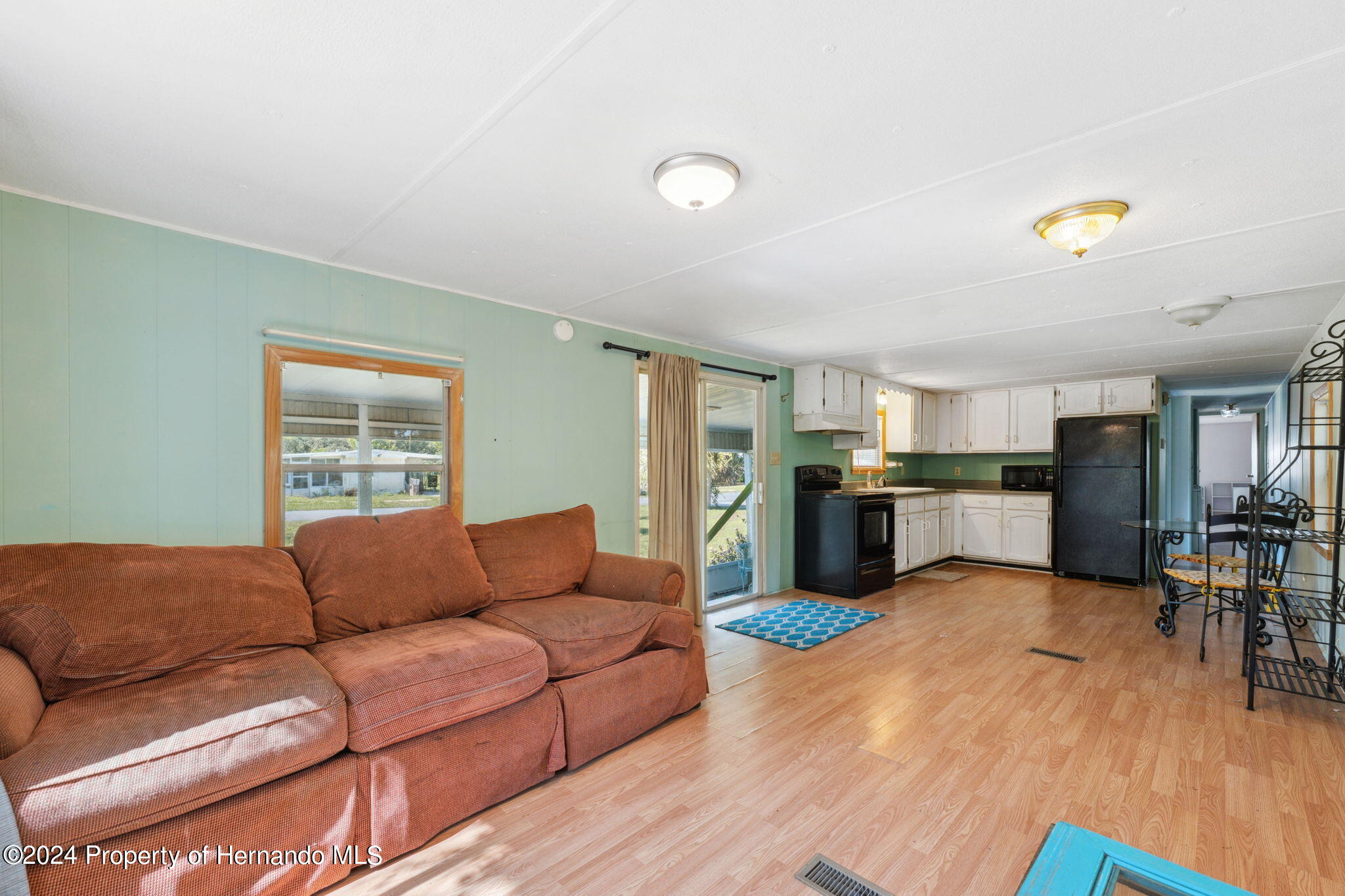 10327 East Victory Lane Inverness, FL 34450 - Photo 9 of 35 a living room with furniture and kitchen view