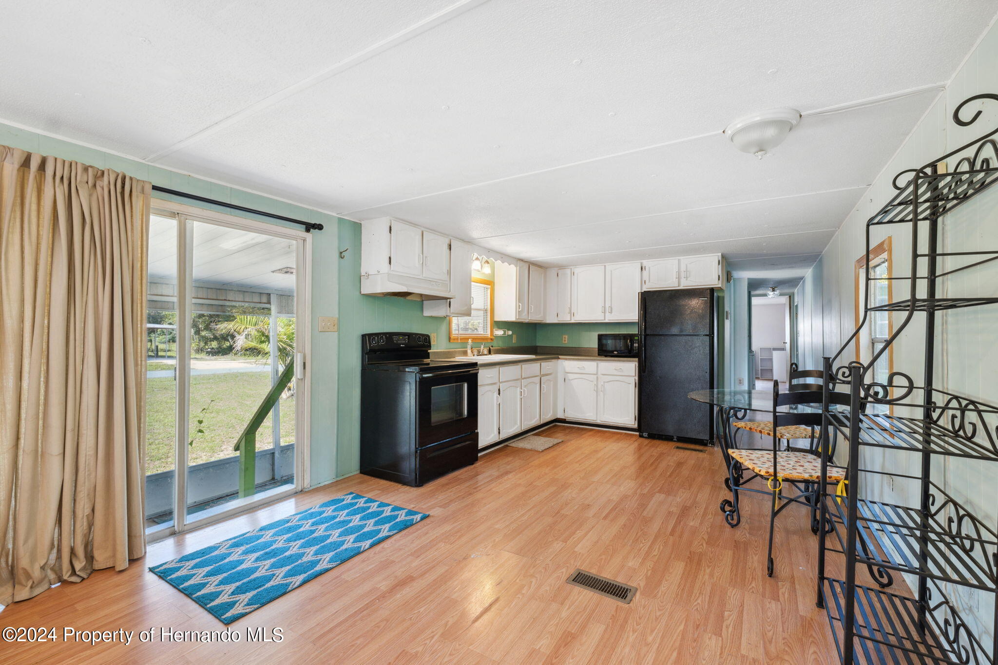 10327 East Victory Lane Inverness, FL 34450 - Photo 10 of 35 a kitchen with stainless steel appliances granite countertop a refrigerator a stove top oven and a granite counter top