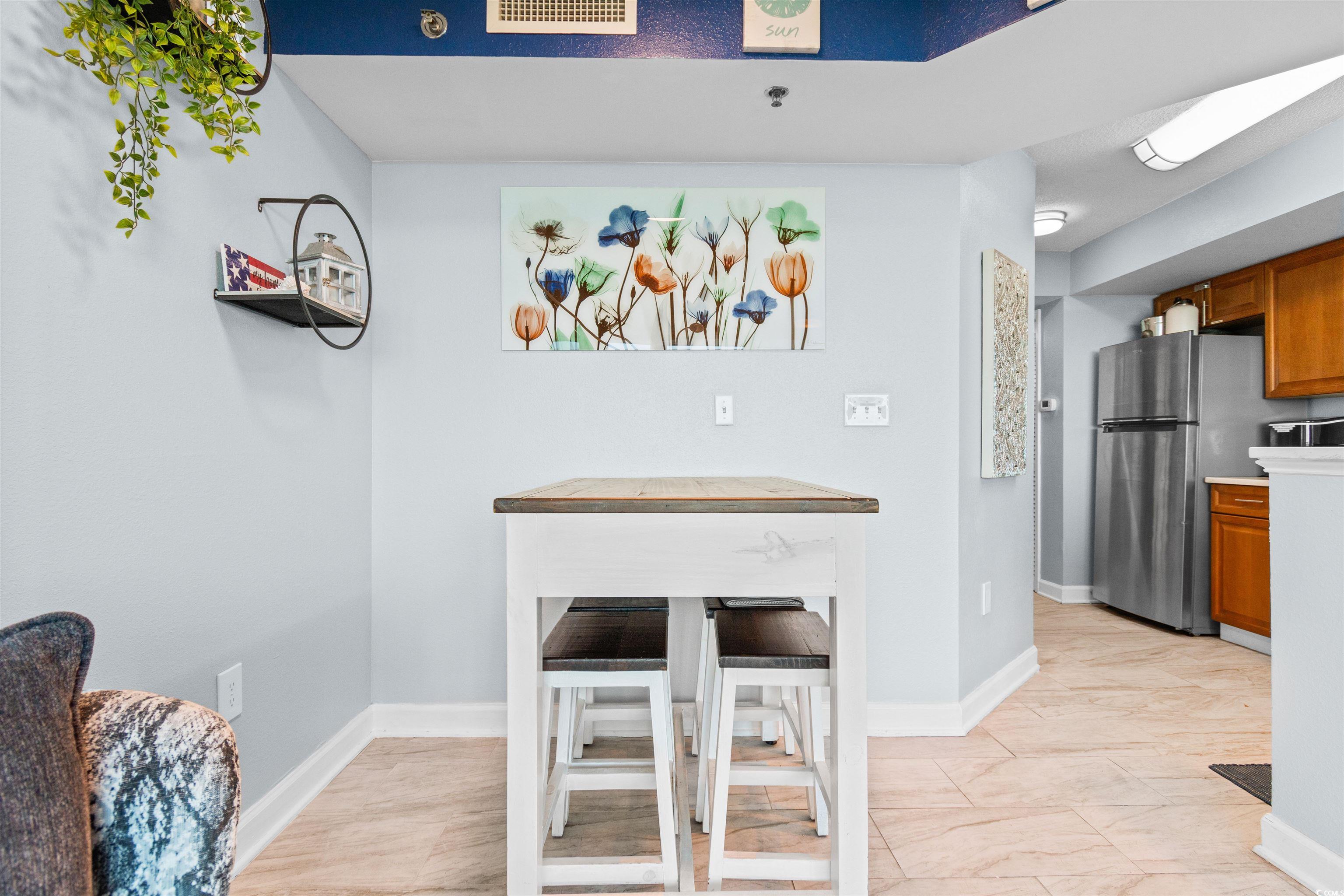 215 77th Avenue North, Unit 603 Myrtle Beach, SC 29572 - Photo 11 of 37 Dining space featuring baseboards