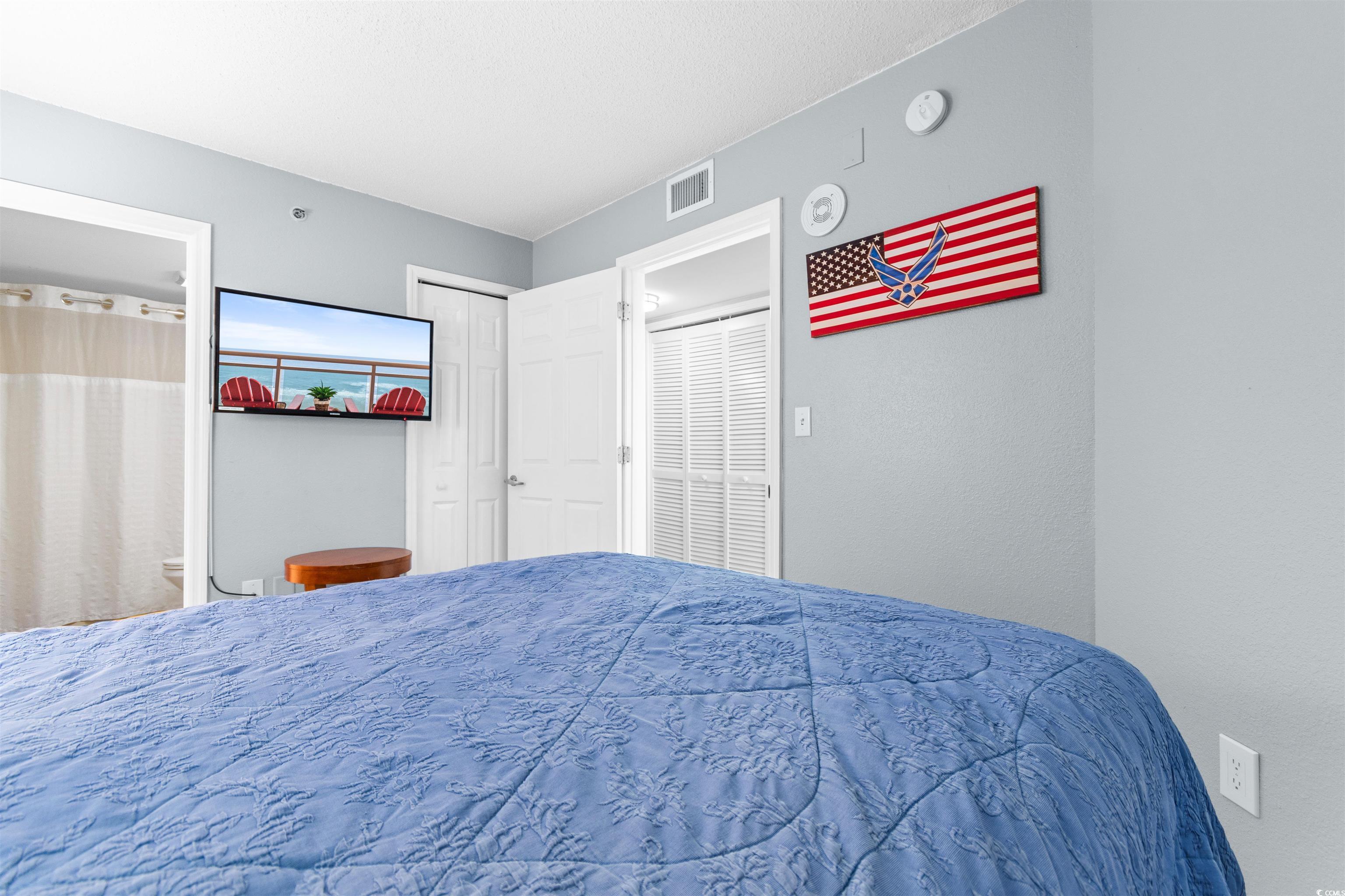 215 77th Avenue North, Unit 603 Myrtle Beach, SC 29572 - Photo 16 of 37 Bedroom with connected bathroom and a closet