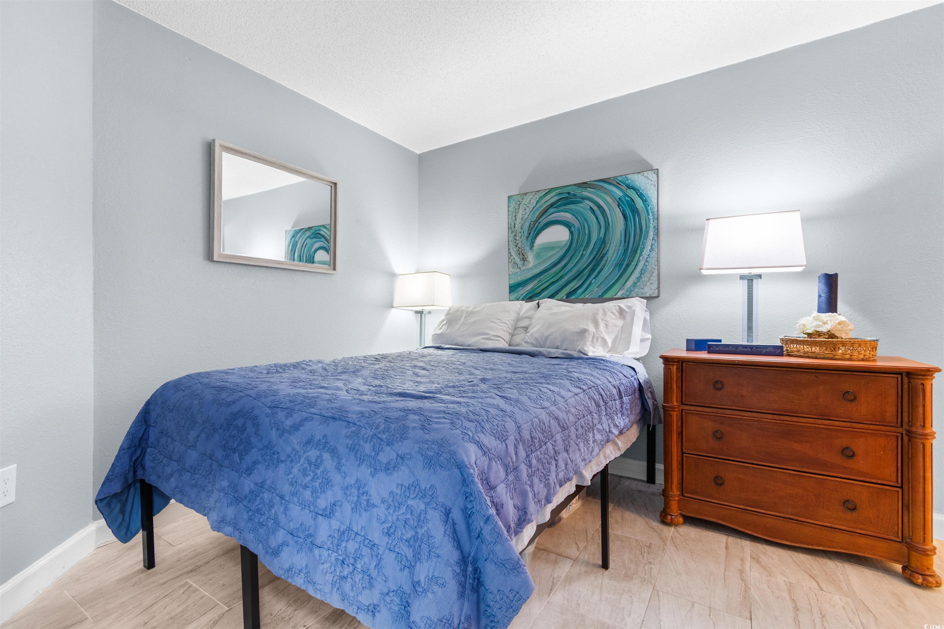 215 77th Avenue North, Unit 603 Myrtle Beach, SC 29572 - Photo 17 of 37 Bedroom with baseboards and light wood-style floors
