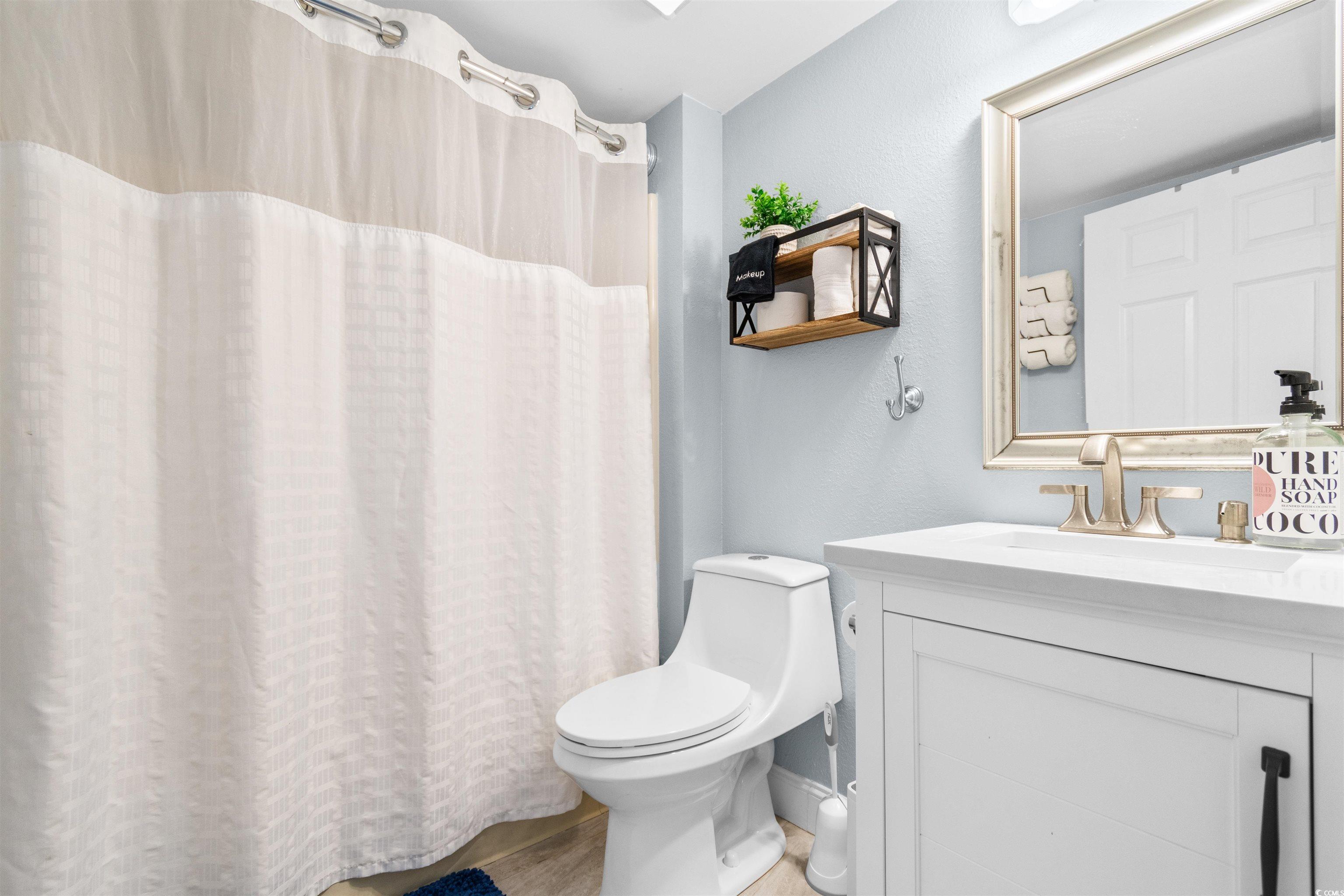 215 77th Avenue North, Unit 603 Myrtle Beach, SC 29572 - Photo 18 of 37 Full bath featuring vanity, light wood-type flooring, and a textured wall