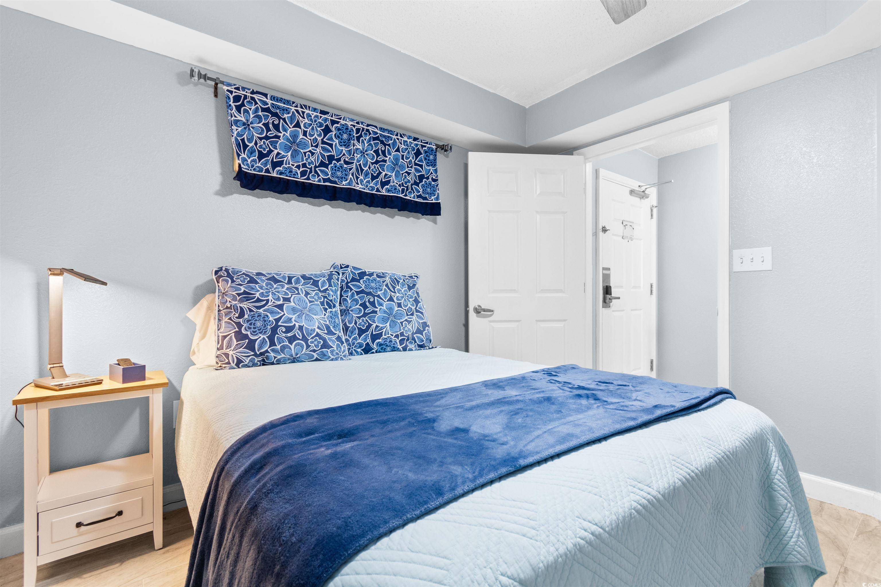 215 77th Avenue North, Unit 603 Myrtle Beach, SC 29572 - Photo 19 of 37 Bedroom with baseboards and light wood-style floors