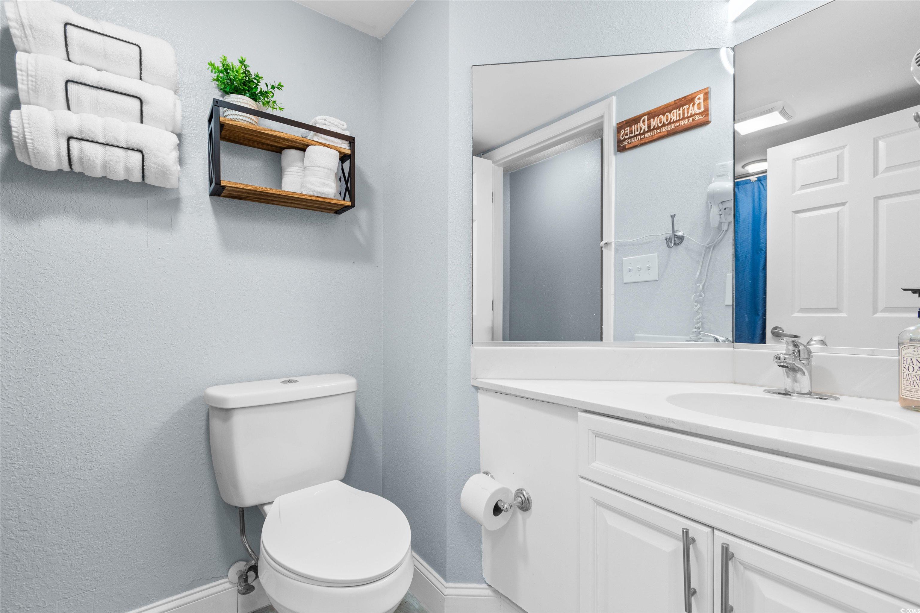 215 77th Avenue North, Unit 603 Myrtle Beach, SC 29572 - Photo 21 of 37 Full bath featuring vanity, a textured wall, and curtained shower