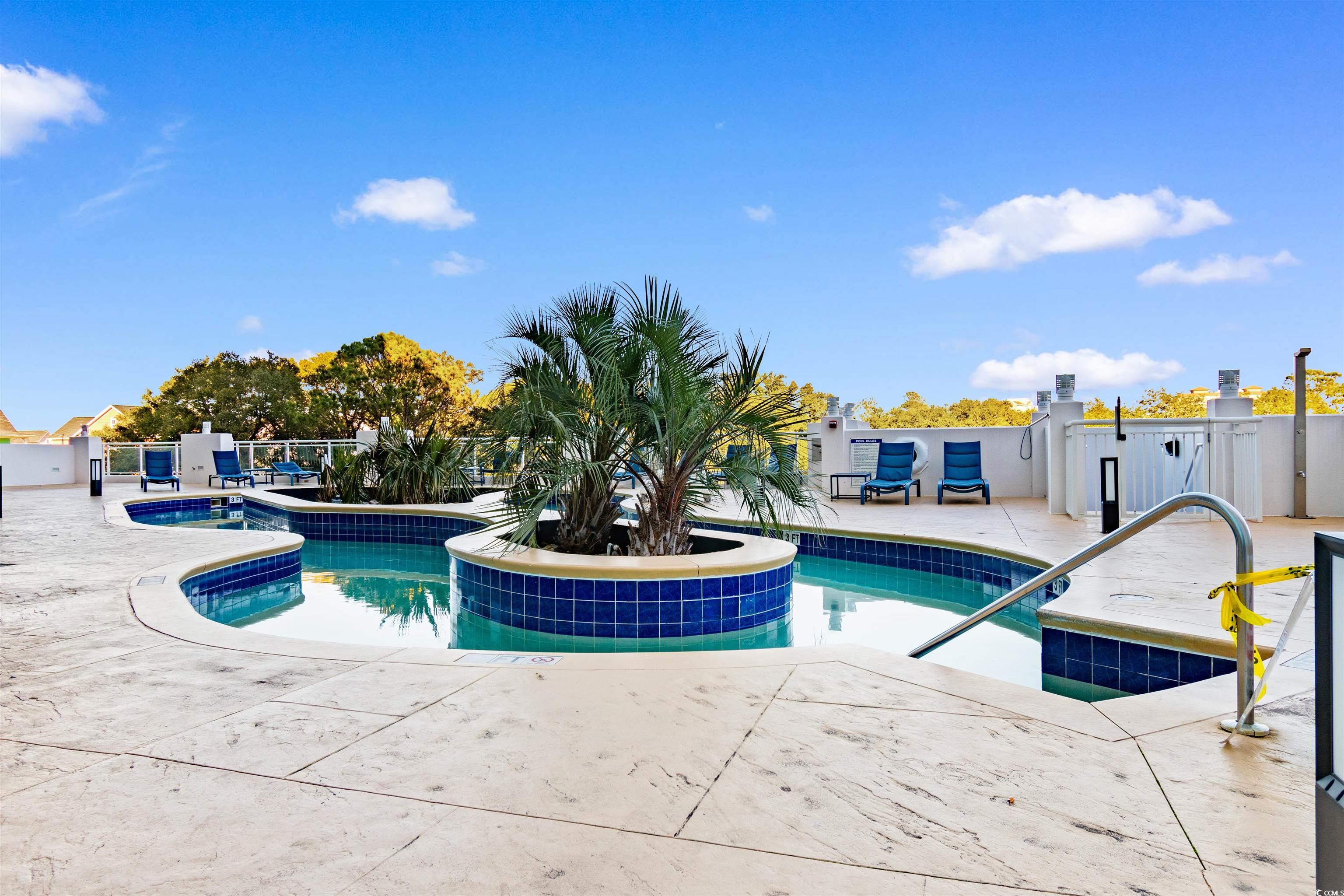 215 77th Avenue North, Unit 603 Myrtle Beach, SC 29572 - Photo 26 of 37 Outdoor pool with a patio