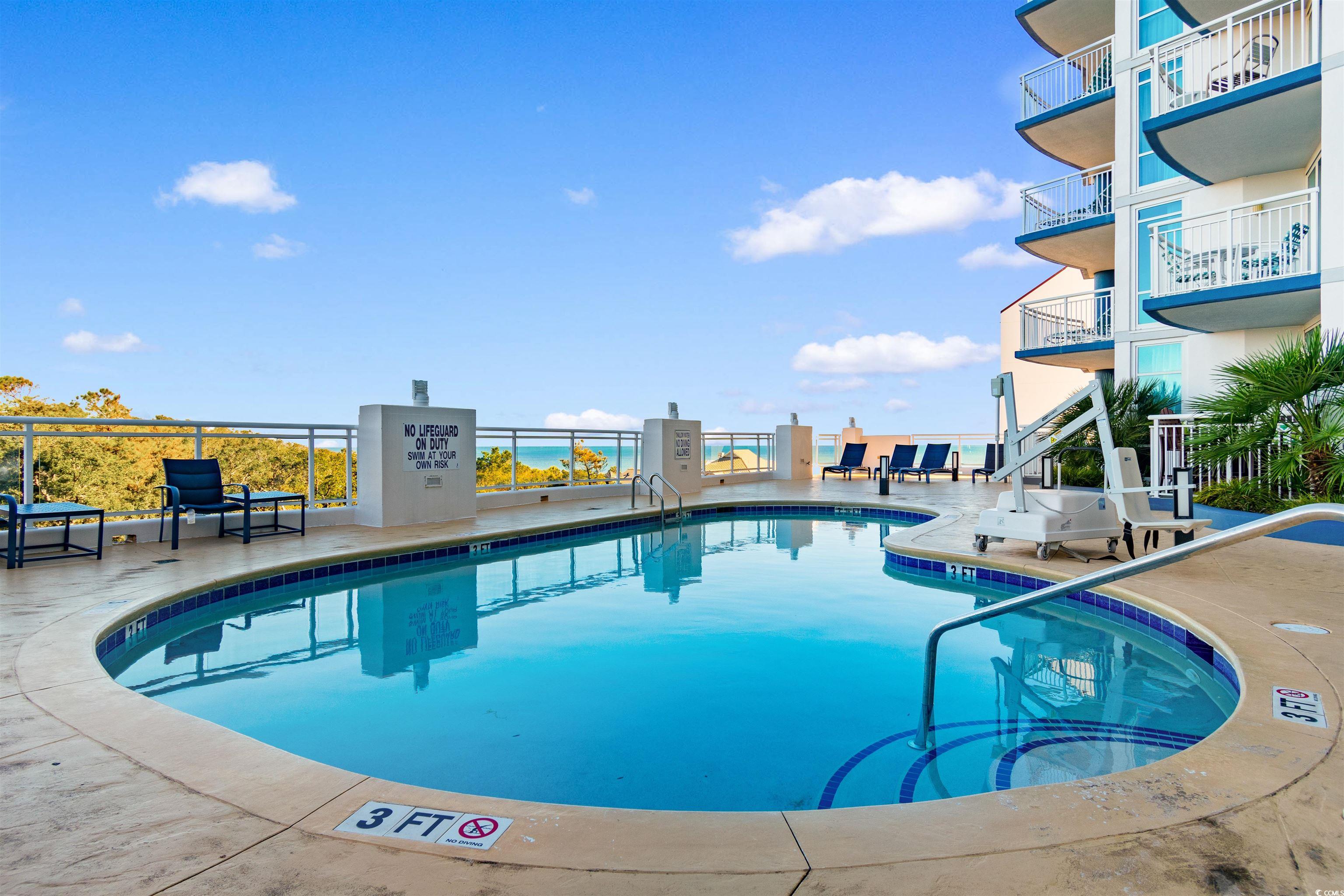 215 77th Avenue North, Unit 603 Myrtle Beach, SC 29572 - Photo 27 of 37 Community pool featuring a patio area