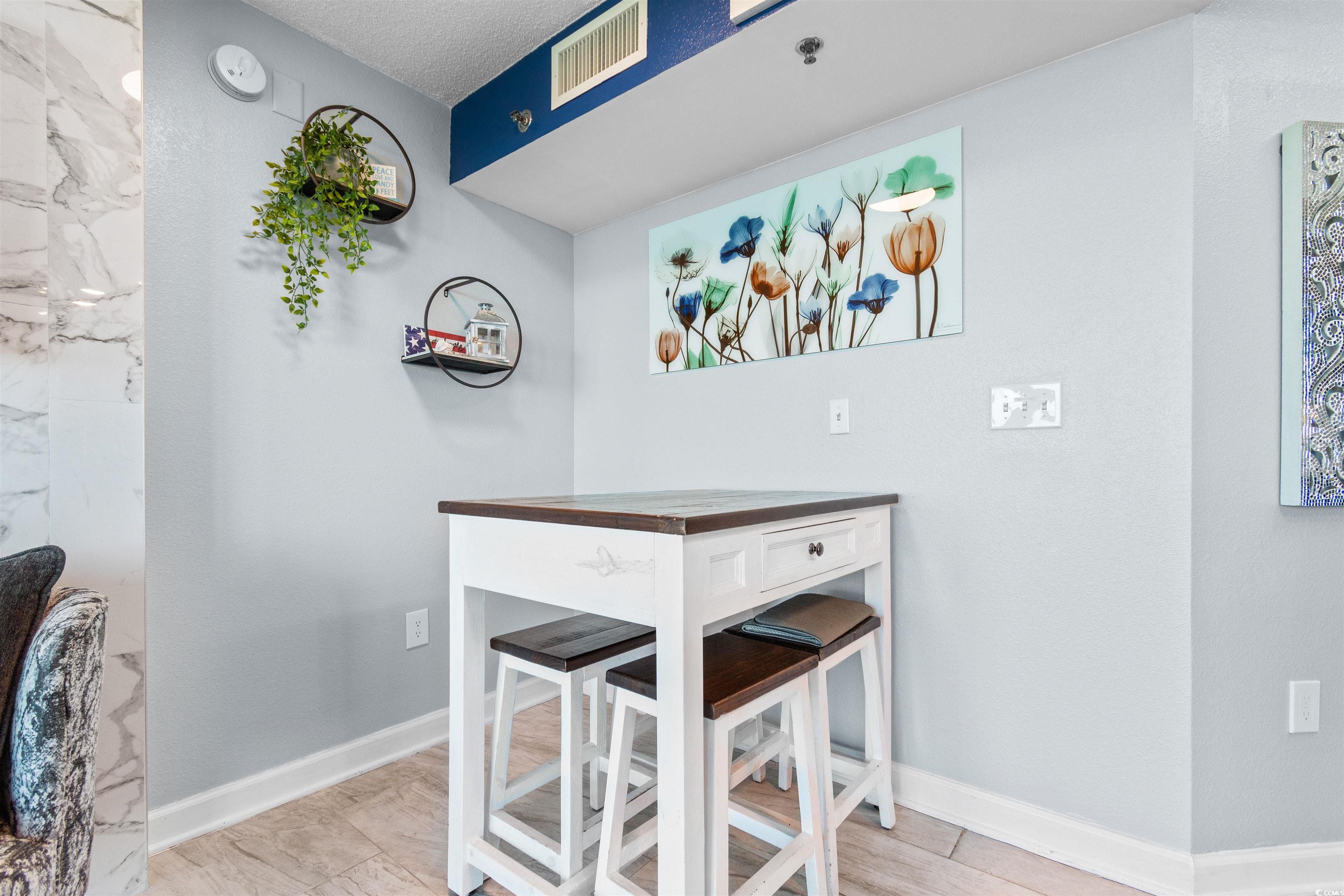 215 77th Avenue North, Unit 603 Myrtle Beach, SC 29572 - Photo 30 of 37 Dining space featuring baseboards