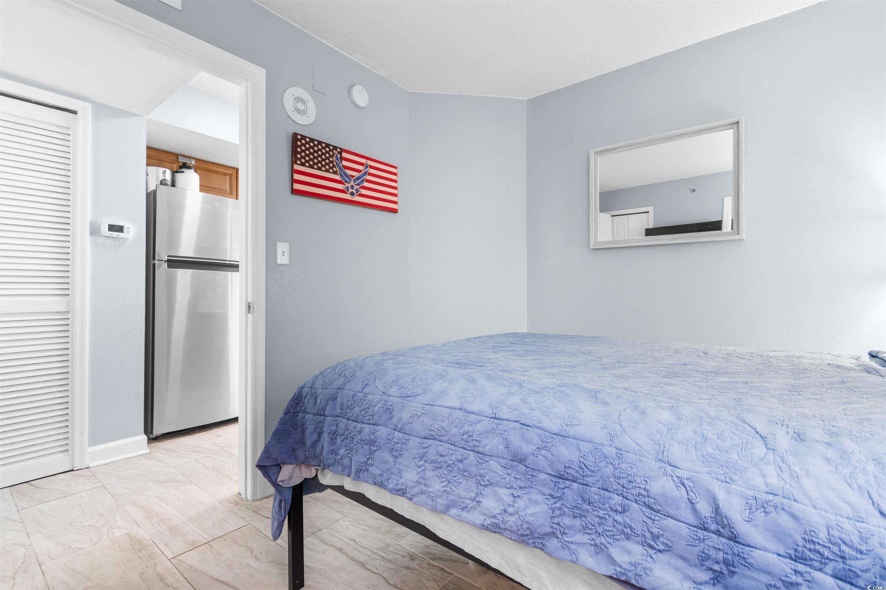 215 77th Avenue North, Unit 603 Myrtle Beach, SC 29572 - Photo 33 of 37 Bedroom featuring freestanding refrigerator