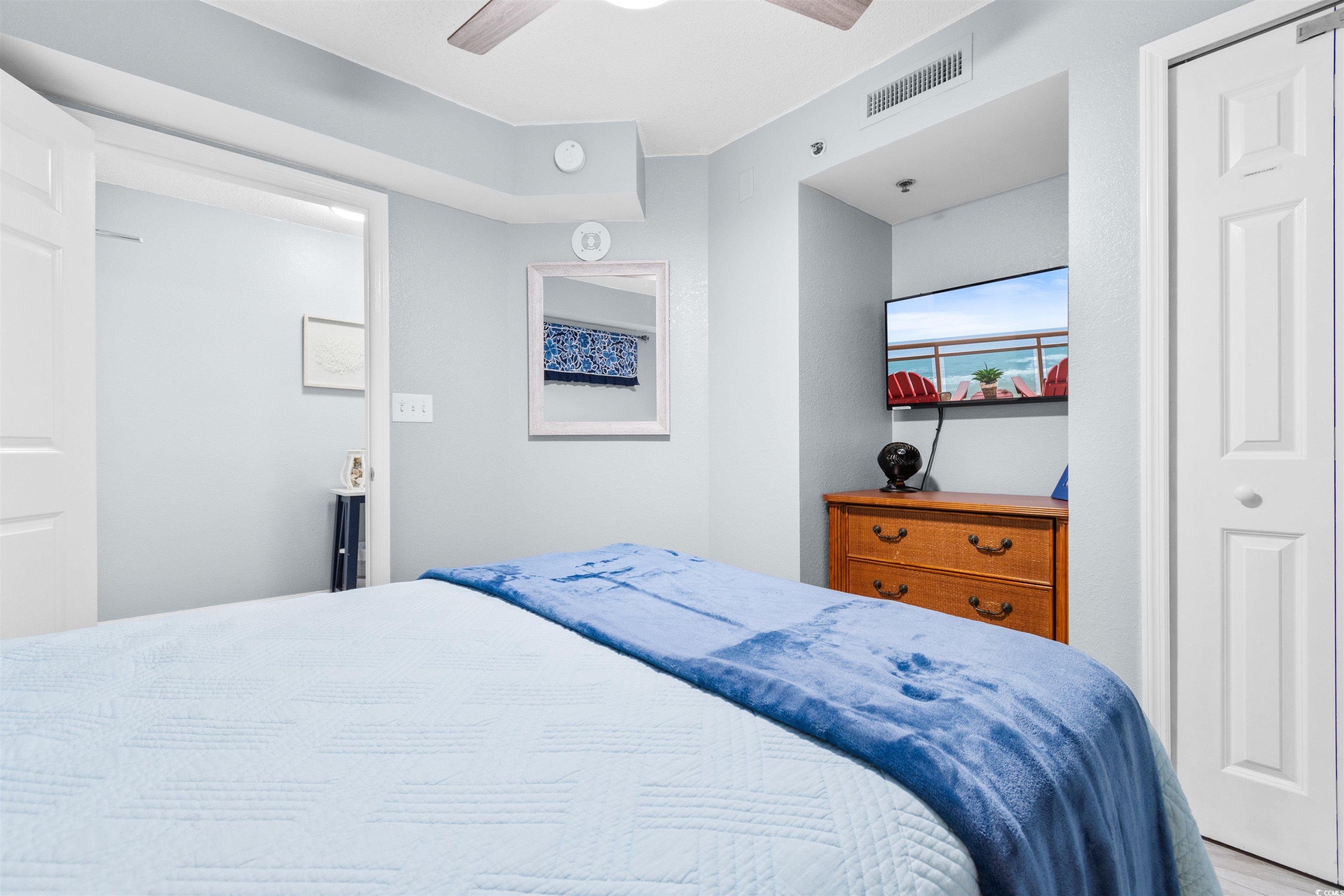 215 77th Avenue North, Unit 603 Myrtle Beach, SC 29572 - Photo 34 of 37 Bedroom featuring ceiling fan and two closets