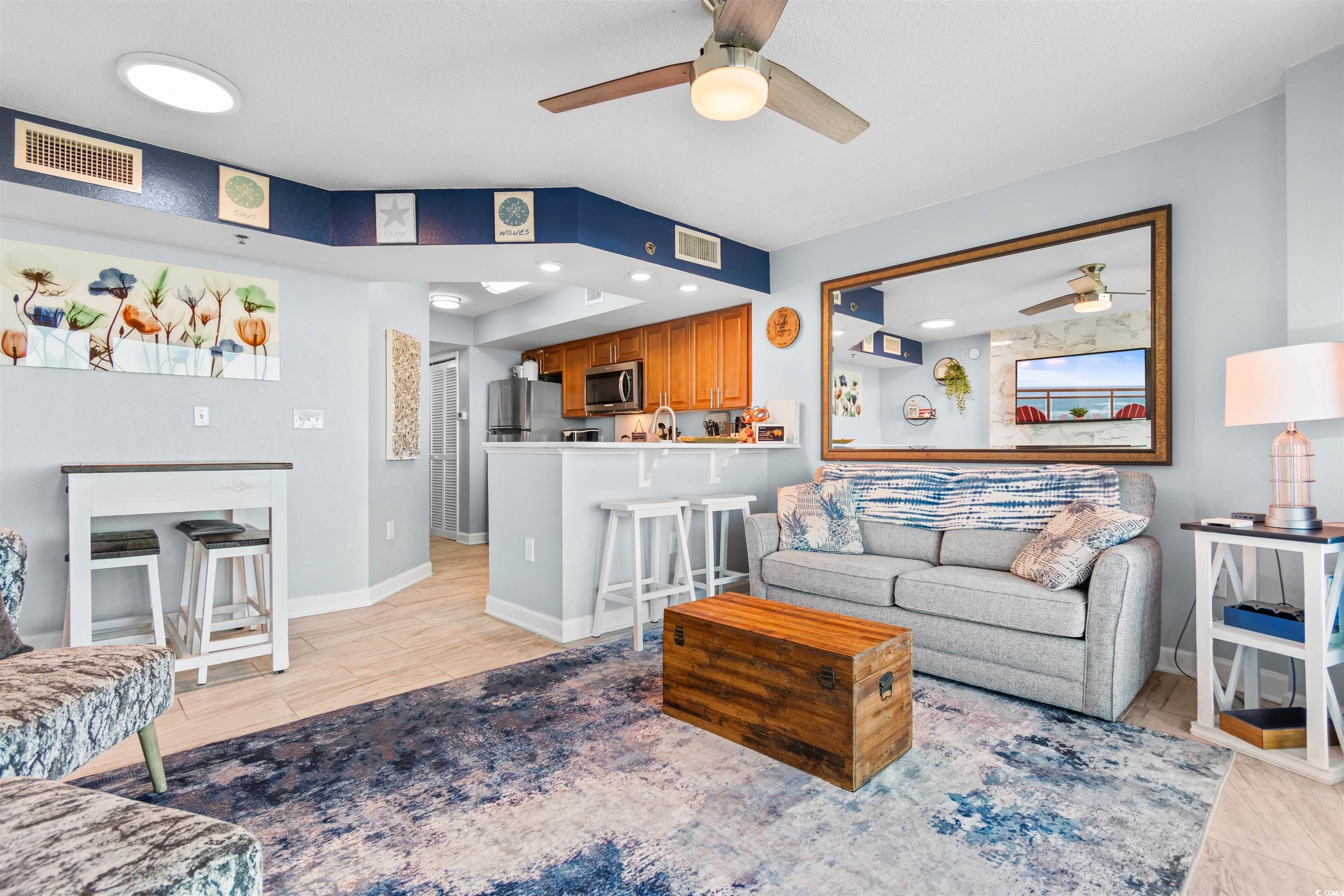 215 77th Avenue North, Unit 603 Myrtle Beach, SC 29572 - Photo 9 of 37 Living area featuring ceiling fan and light wood-type flooring