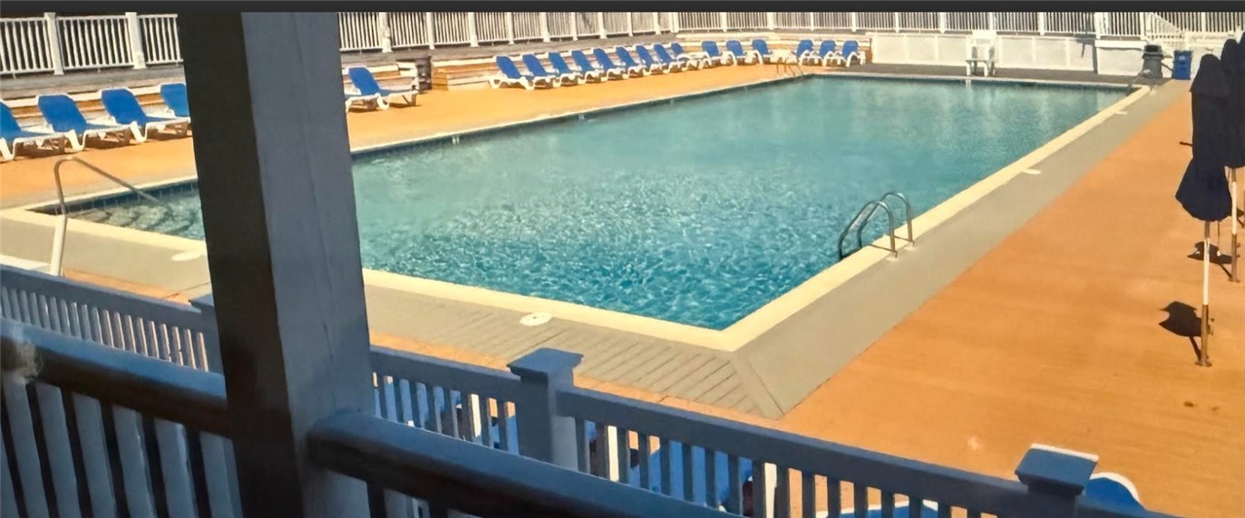 Delightful inground pool surrounded by sand and umbrellas. Island time!