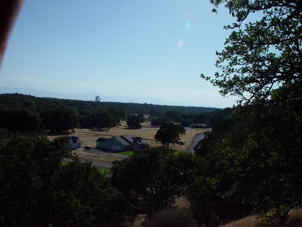 a view of a house in a yard with green space