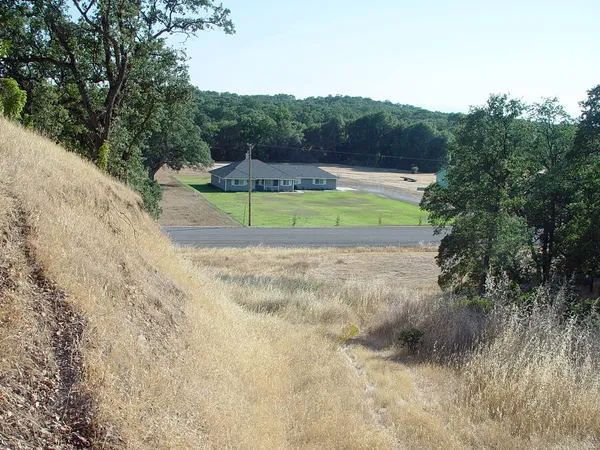 a view of a swimming pool with a yard