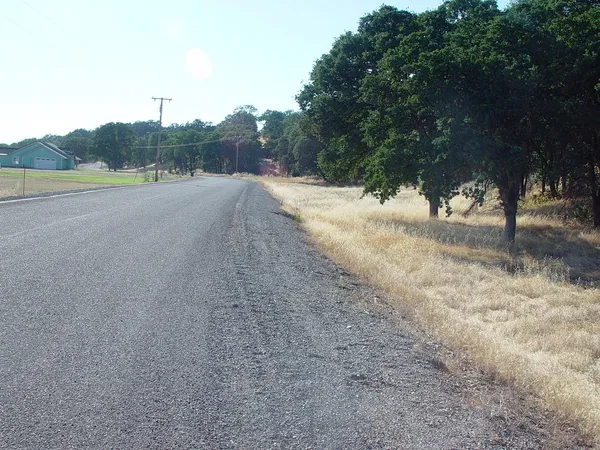 a view of a road with a yard