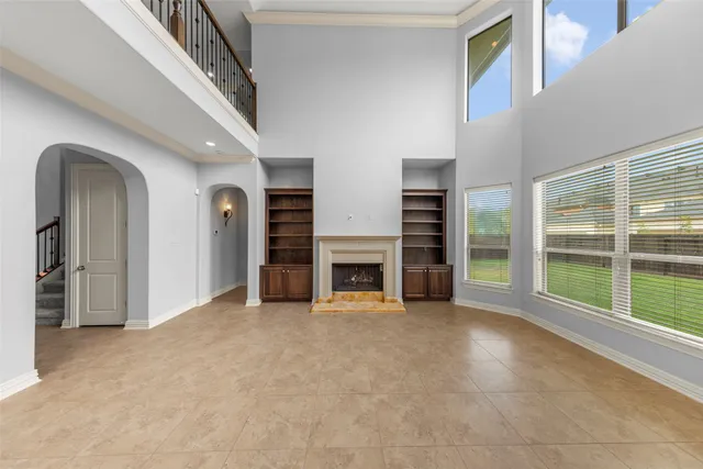 a view of a livingroom with an empty space and a fireplace