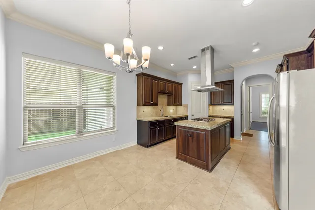 a large kitchen with a large window and stainless steel appliances
