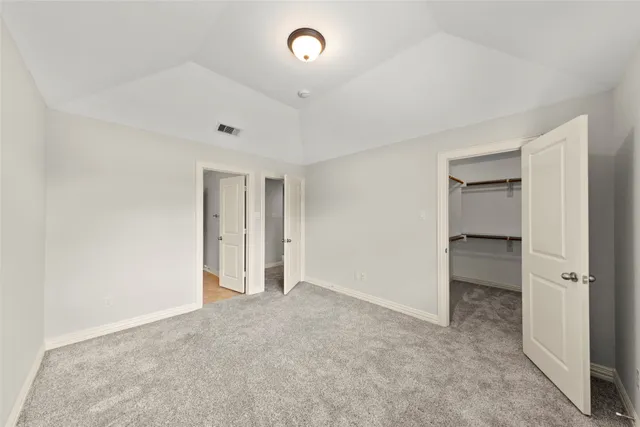 an empty room with closet and a bathroom