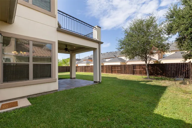 a view of a balcony with wooden floor and fence