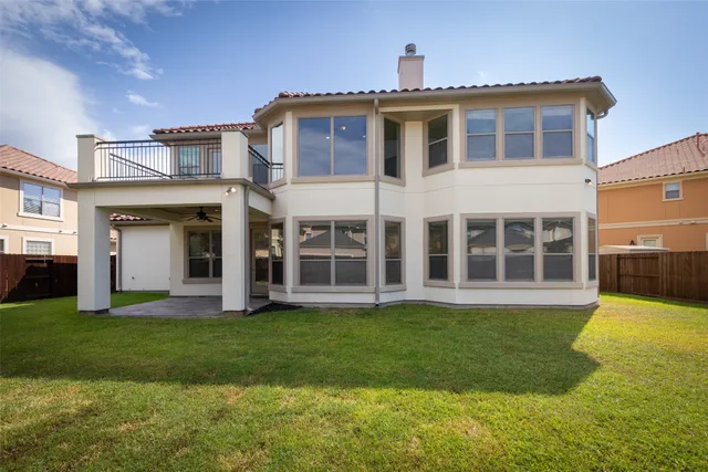 an aerial view of lake and residential houses with outdoor space