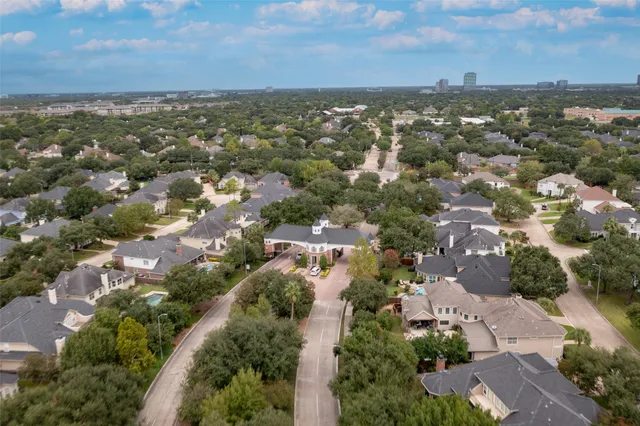 an aerial view of residential houses with city view